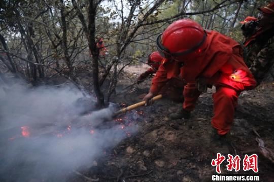 森警官兵清理火场。　李传永 摄